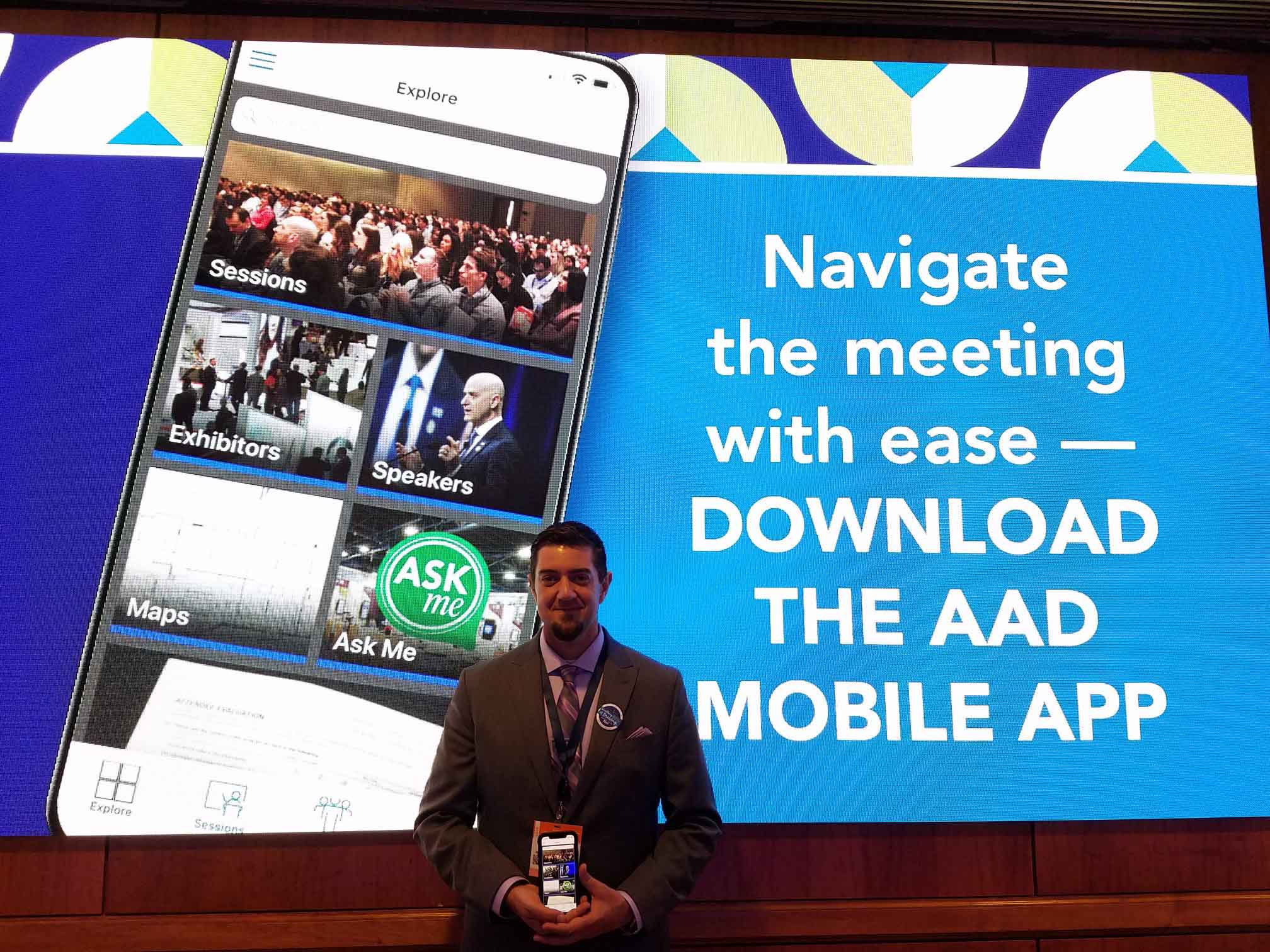 A picture of me holding up the American Academy of Dermatology's mobile meeting app after launching live at a conference.